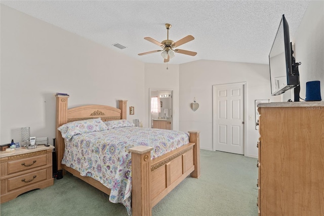 bedroom featuring lofted ceiling, visible vents, a textured ceiling, and light colored carpet