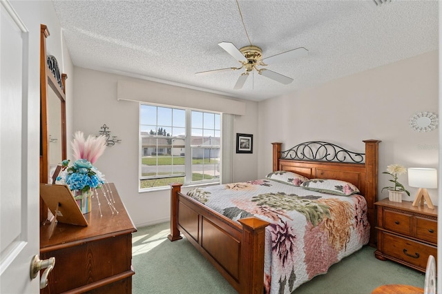 carpeted bedroom featuring a textured ceiling and ceiling fan