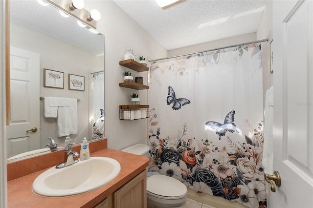 bathroom featuring toilet, tile patterned floors, curtained shower, a textured ceiling, and vanity