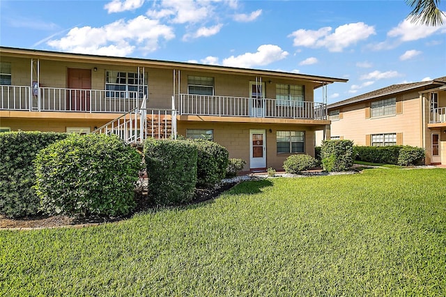 view of property with a front yard and stairway