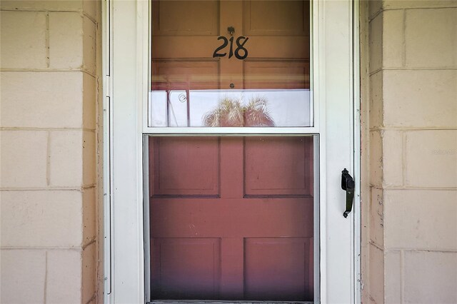 entrance to property featuring concrete block siding