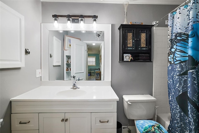 bathroom featuring toilet, shower / bathtub combination with curtain, and vanity