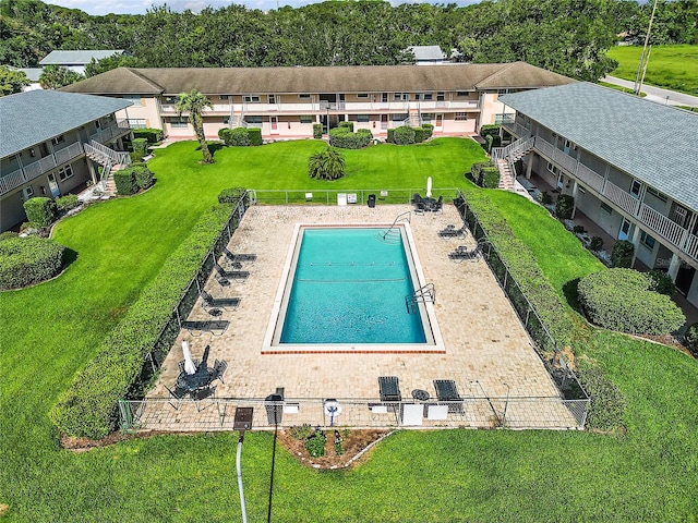 view of swimming pool featuring fence