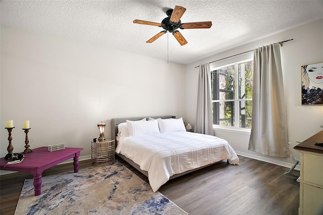 bedroom with baseboards, a ceiling fan, a textured ceiling, and wood finished floors