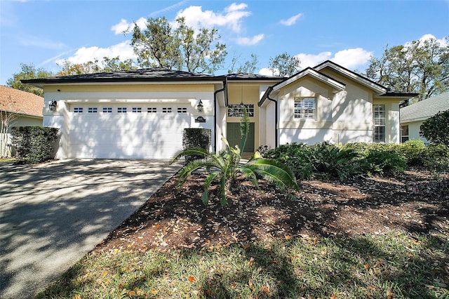 single story home with concrete driveway, stucco siding, and an attached garage