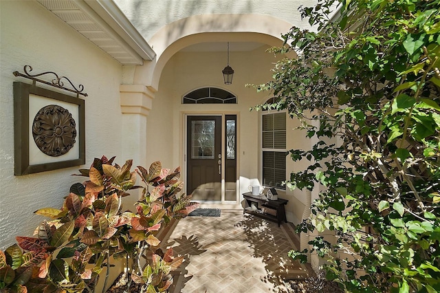 doorway to property with stucco siding