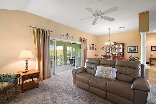 carpeted living area featuring vaulted ceiling, ceiling fan with notable chandelier, visible vents, and ornate columns