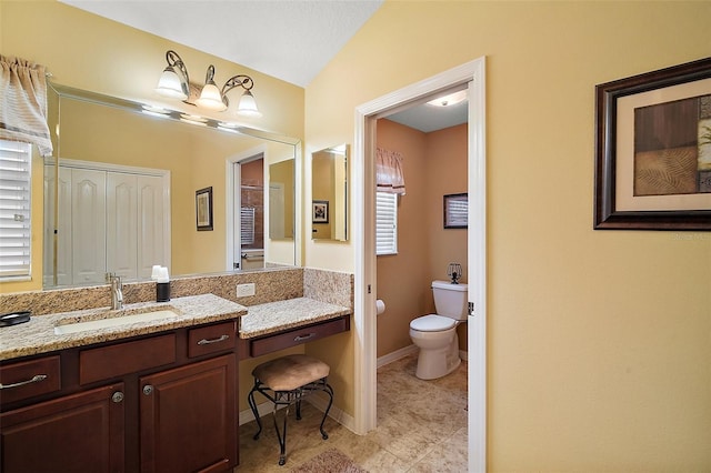 full bathroom featuring tile patterned flooring, vanity, toilet, and baseboards