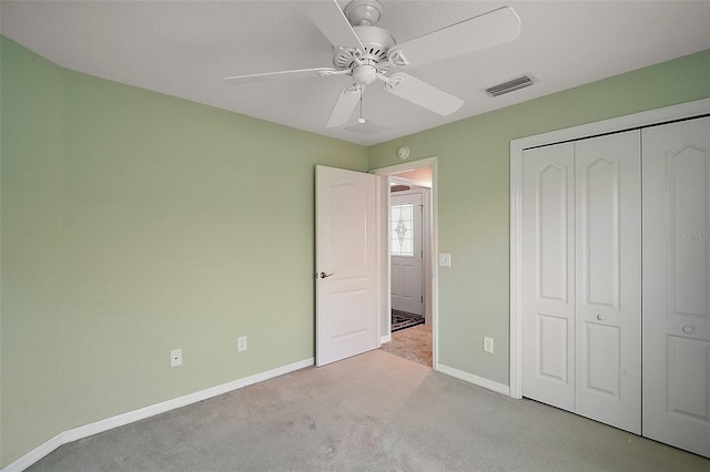 unfurnished bedroom with baseboards, a closet, visible vents, and carpet flooring