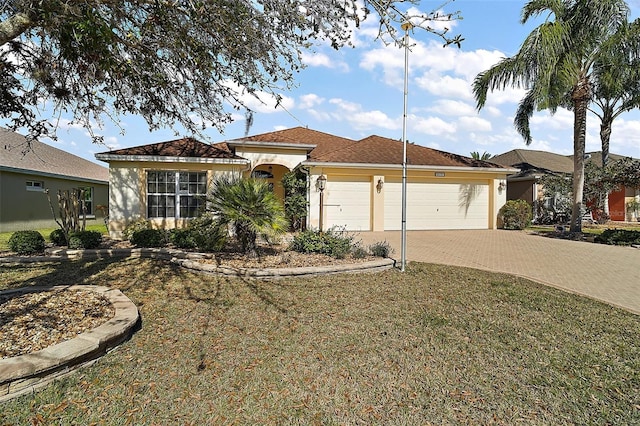 view of front of house with decorative driveway, an attached garage, and stucco siding