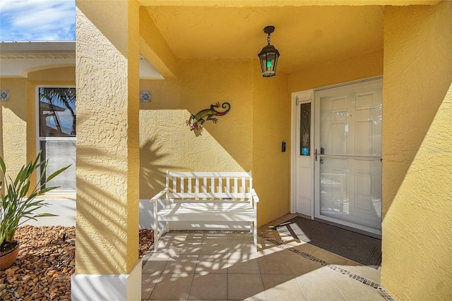 property entrance featuring stucco siding