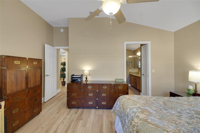 bedroom featuring lofted ceiling, light wood-type flooring, ceiling fan, and ensuite bathroom