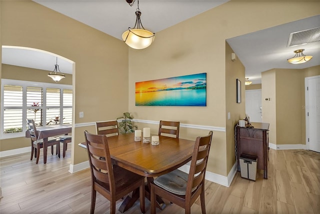 dining area featuring light wood-type flooring, baseboards, and visible vents