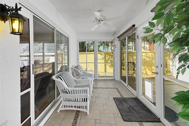 sunroom featuring a healthy amount of sunlight and ceiling fan