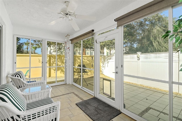 sunroom / solarium with a ceiling fan