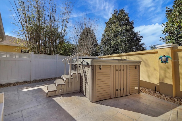 exterior space featuring a fenced backyard and a jacuzzi