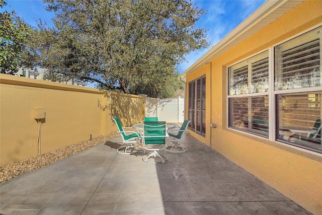 view of patio featuring fence