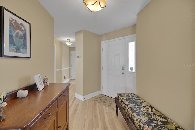 foyer featuring light wood-type flooring and baseboards