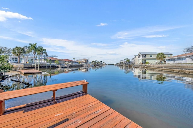 view of dock with a water view and a residential view