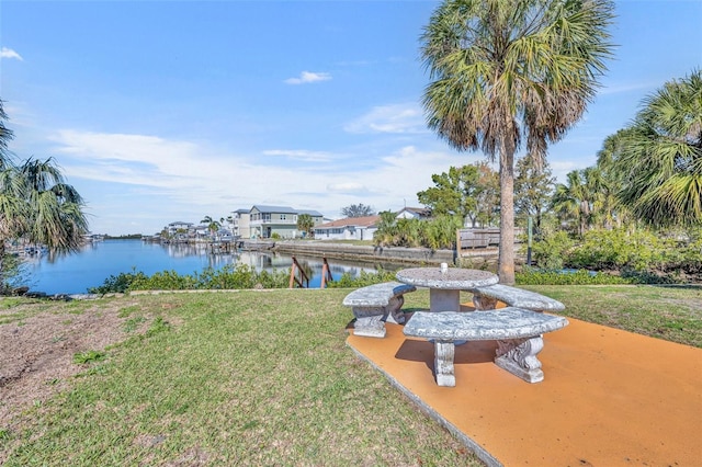 view of dock featuring a water view and a yard