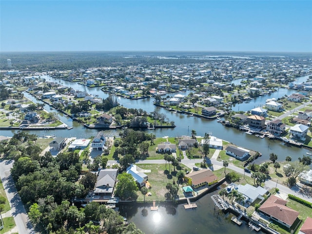 drone / aerial view featuring a water view and a residential view