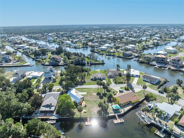 drone / aerial view featuring a water view and a residential view