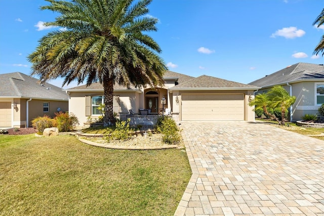 ranch-style house with a front lawn, decorative driveway, an attached garage, and stucco siding