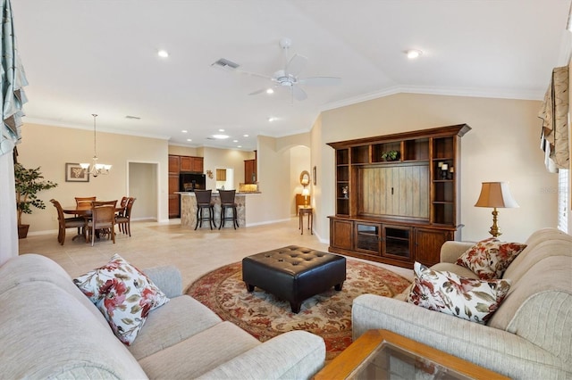 living room featuring arched walkways, light tile patterned floors, lofted ceiling, ceiling fan with notable chandelier, and ornamental molding