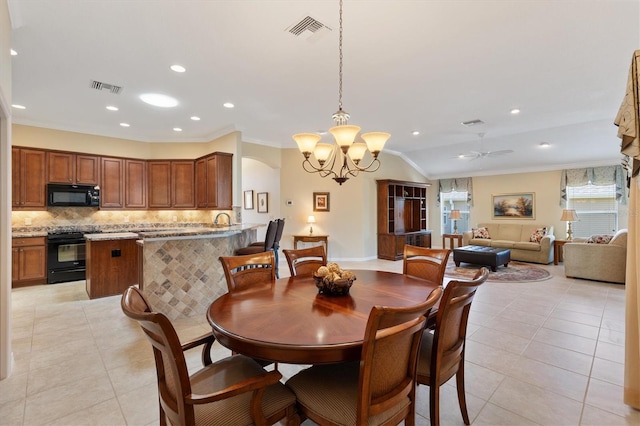 dining room featuring light tile patterned flooring, visible vents, and crown molding