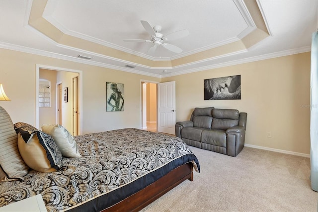 carpeted bedroom with ornamental molding, a tray ceiling, and visible vents