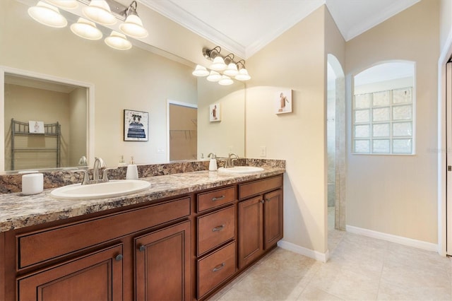 full bath with double vanity, baseboards, ornamental molding, and a sink