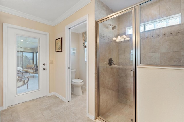 full bath with tile patterned flooring, toilet, baseboards, ornamental molding, and a stall shower