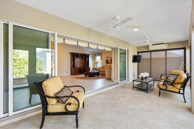 living area with ceiling fan, an AC wall unit, and a healthy amount of sunlight