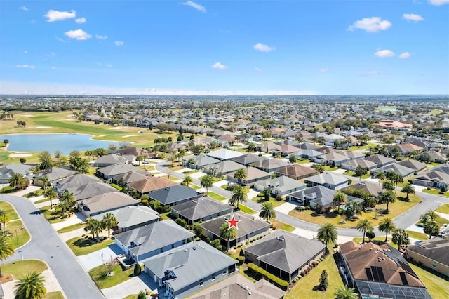 drone / aerial view with a water view, view of golf course, and a residential view