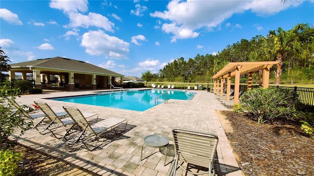 pool with a patio area and fence