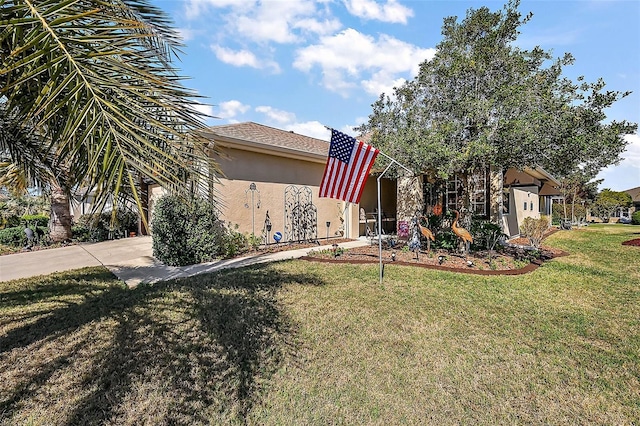 view of front of home with a front yard and stucco siding