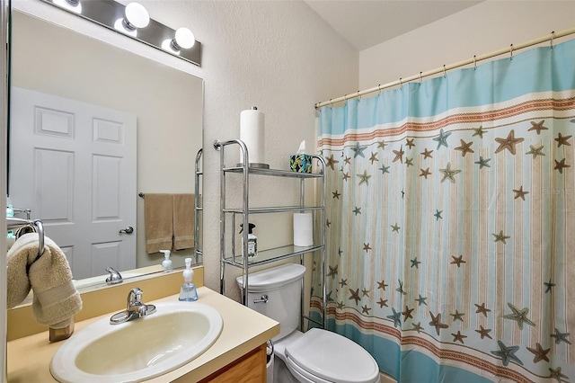 full bath featuring toilet, a shower with shower curtain, and vanity