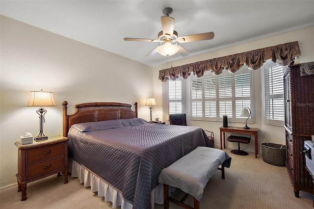 bedroom with light carpet, a ceiling fan, and baseboards