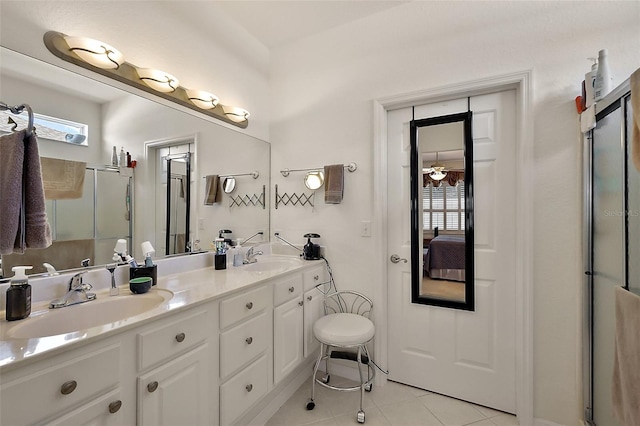 bathroom with tile patterned floors, an enclosed shower, a sink, and double vanity