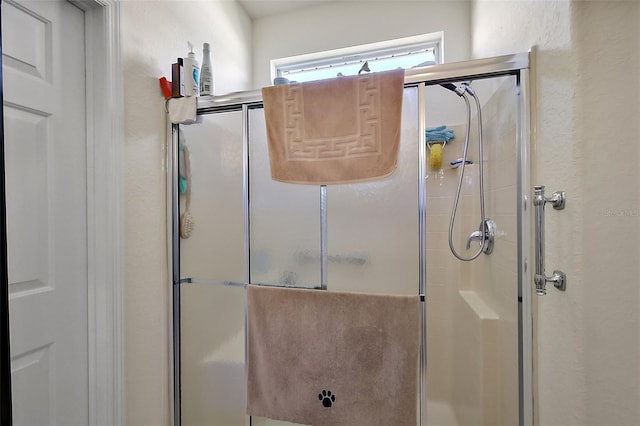 bathroom with a shower stall