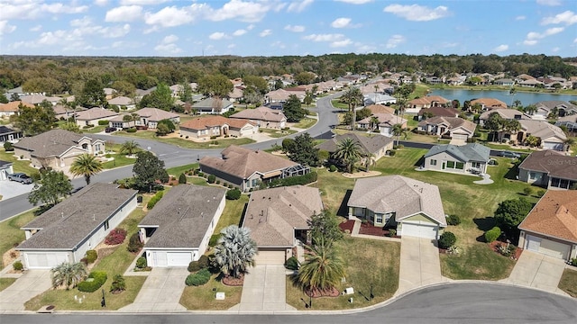 bird's eye view featuring a water view and a residential view