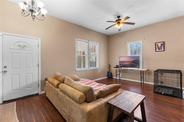 living room with baseboards, wood finished floors, and ceiling fan with notable chandelier