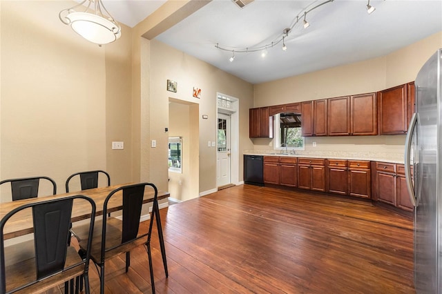 kitchen featuring dishwasher, dark wood-style floors, freestanding refrigerator, light countertops, and a sink