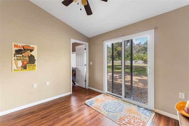 empty room with lofted ceiling, ceiling fan, baseboards, and wood finished floors