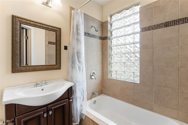 bathroom with tiled shower / bath and vanity