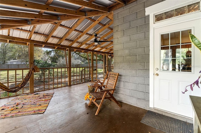 unfurnished sunroom featuring ceiling fan