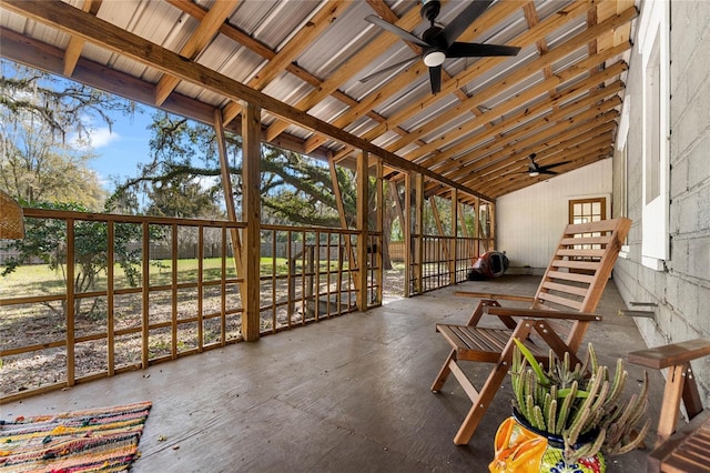 sunroom / solarium with a ceiling fan and vaulted ceiling