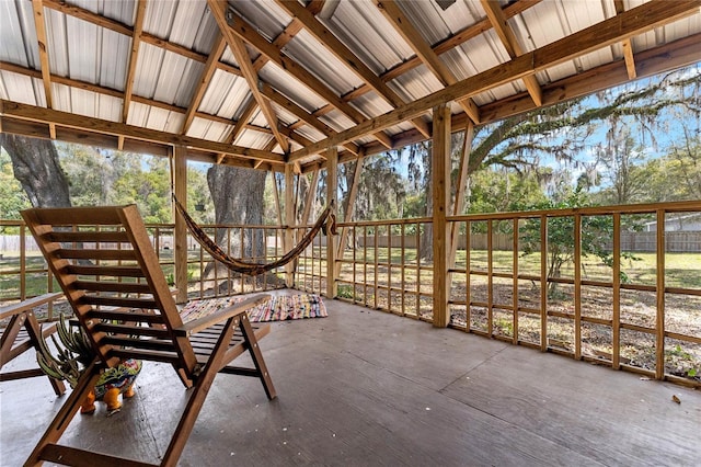 unfurnished sunroom featuring vaulted ceiling