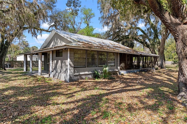 view of side of home with a sunroom