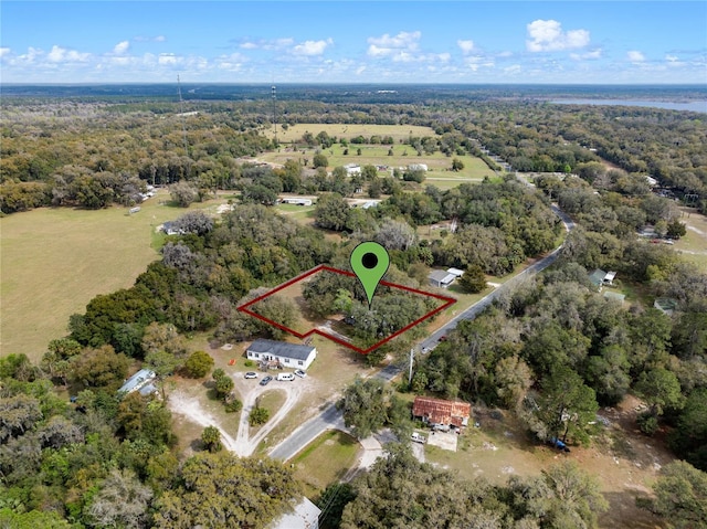 drone / aerial view featuring a forest view